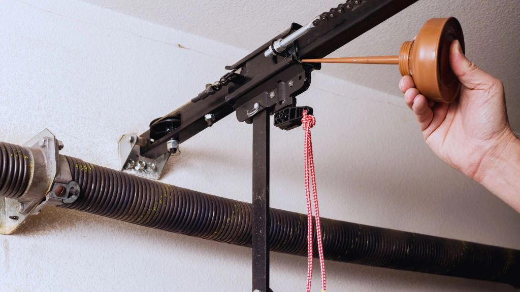 Close-up view of properly lubricated garage door roller moving smoothly along metal track