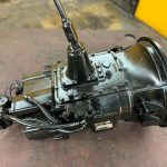 A detailed view of an Eaton Fuller heavy-duty truck transmission, showing the main box and gear components