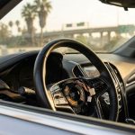 Car steering wheel with non-working buttons under bright Los Angeles sunlight showing heat damage effects