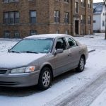 Snow-covered car parked overnight in Milwaukee winter